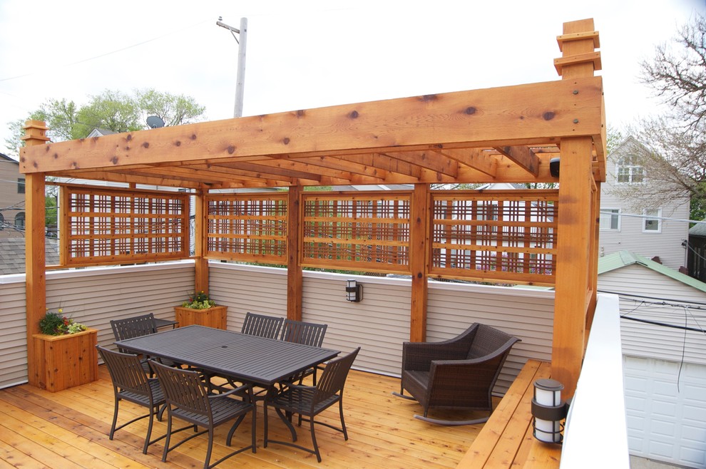 Photo of a mid-sized industrial rooftop deck in Chicago with a pergola.