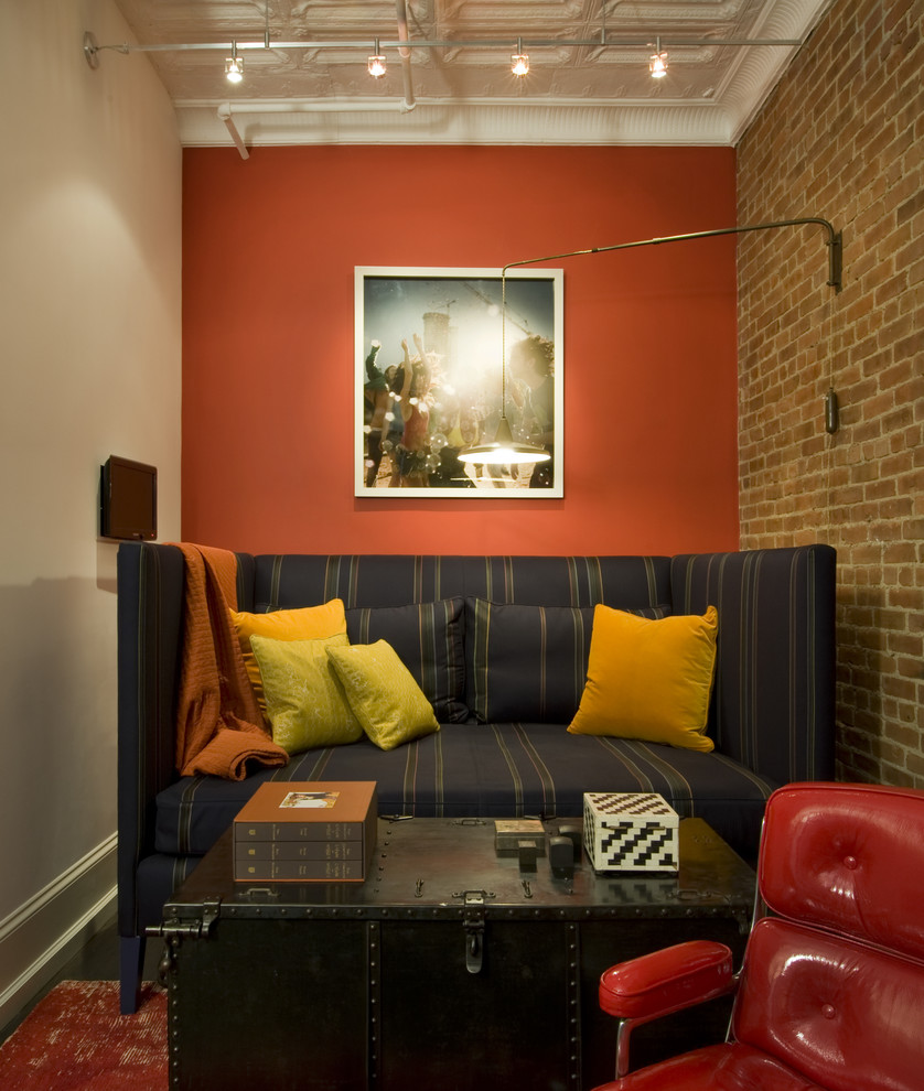 Design ideas for an industrial family room in New York with orange walls.