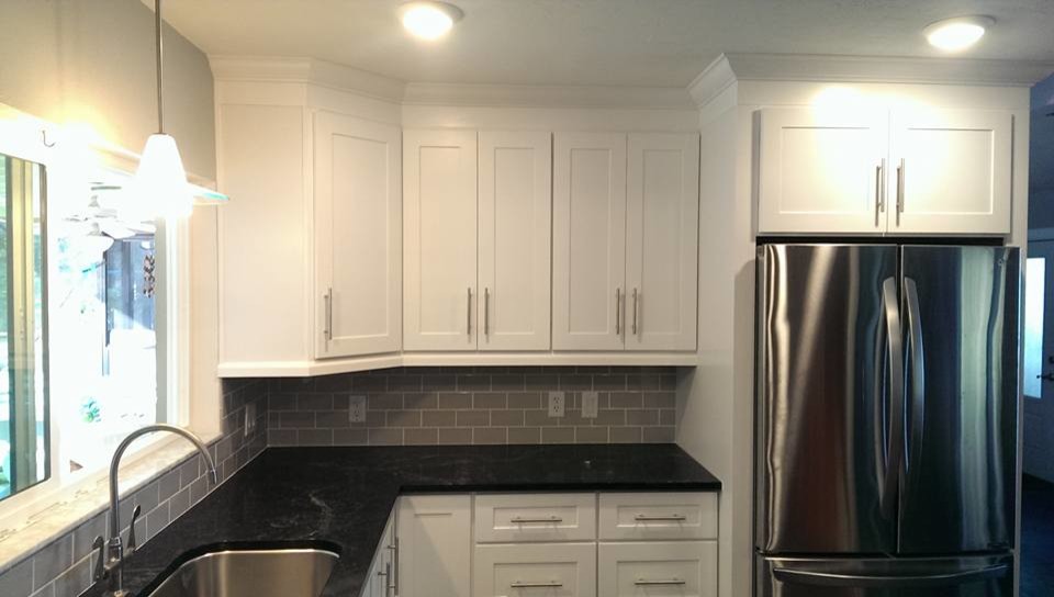 Inspiration for a mid-sized transitional u-shaped ceramic tile and black floor eat-in kitchen remodel in Miami with shaker cabinets, white cabinets, laminate countertops, gray backsplash, stainless steel appliances, an undermount sink, subway tile backsplash, a peninsula and black countertops