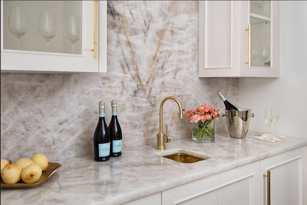 Inspiration for a mid-sized transitional single-wall wet bar in Atlanta with an undermount sink, beaded inset cabinets, white cabinets, marble benchtops, multi-coloured splashback, marble splashback, dark hardwood floors and brown floor.