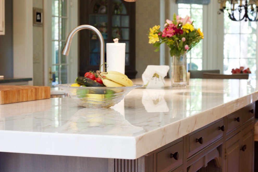 Example of a large transitional dark wood floor eat-in kitchen design in DC Metro with marble countertops, an island, brown cabinets, white backsplash and stainless steel appliances