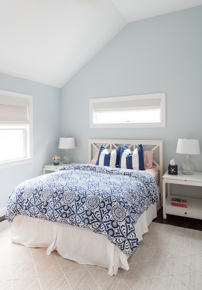 Design ideas for a beach style master bedroom in New York with blue walls and brown floor.