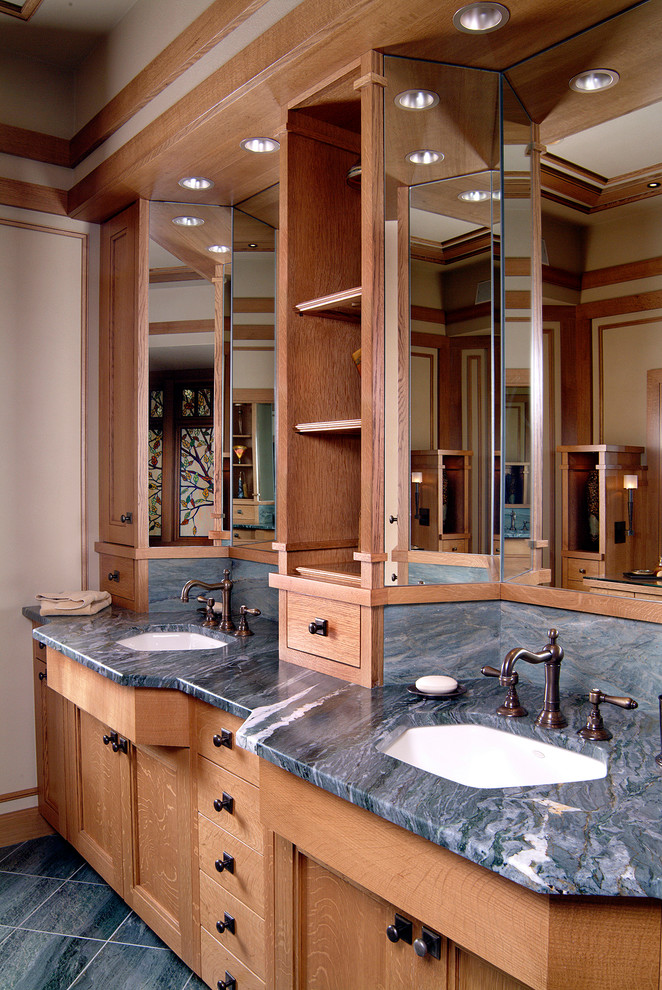 This is an example of a large arts and crafts master bathroom in Kansas City with shaker cabinets, medium wood cabinets, an undermount tub, a two-piece toilet, white walls, porcelain floors, an undermount sink and marble benchtops.