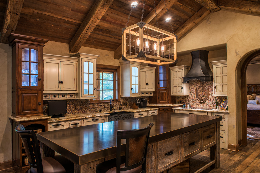 Design ideas for a large country u-shaped separate kitchen in Other with a farmhouse sink, recessed-panel cabinets, distressed cabinets, with island, granite benchtops, brown splashback, panelled appliances and dark hardwood floors.