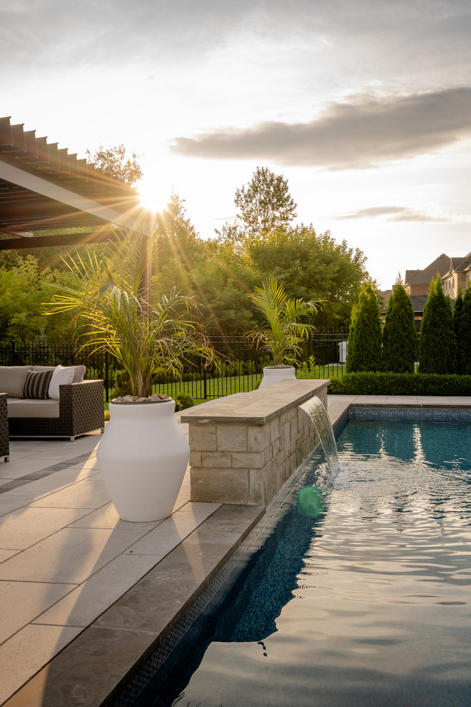 Inspiration for a large transitional backyard concrete paver and rectangular lap pool landscaping remodel in Toronto