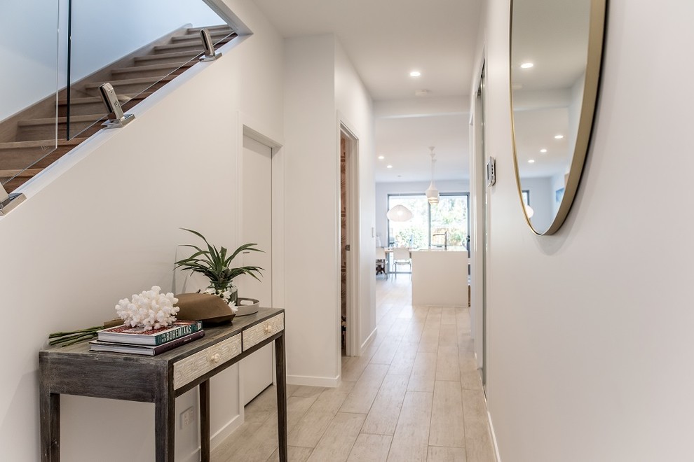 This is an example of a small tropical entry hall in Sunshine Coast with white walls.