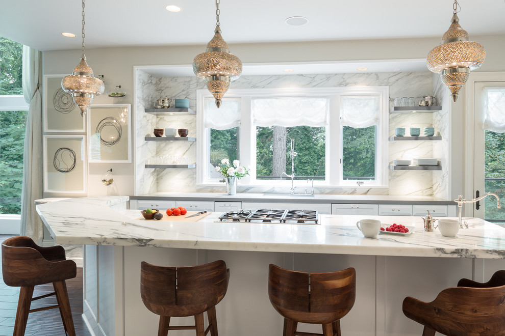 Example of a transitional galley dark wood floor kitchen design in Portland with shaker cabinets, white cabinets, white backsplash and an island