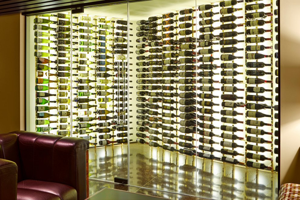 This is an example of an expansive contemporary wine cellar in Orange County with display racks and multi-coloured floor.