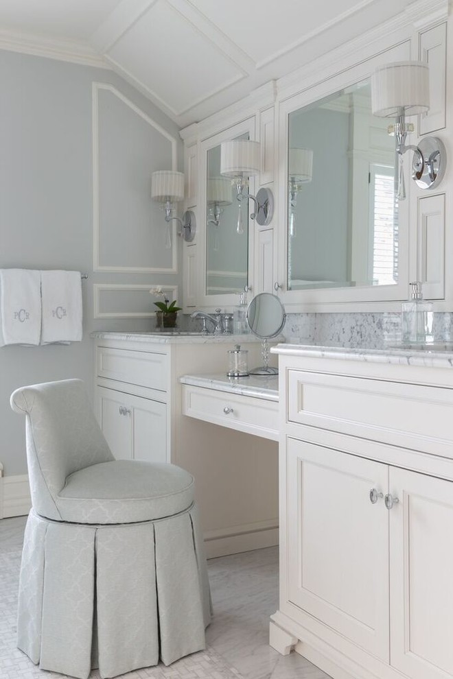 This is an example of a traditional bathroom in New York with white cabinets, grey walls, an undermount sink and recessed-panel cabinets.