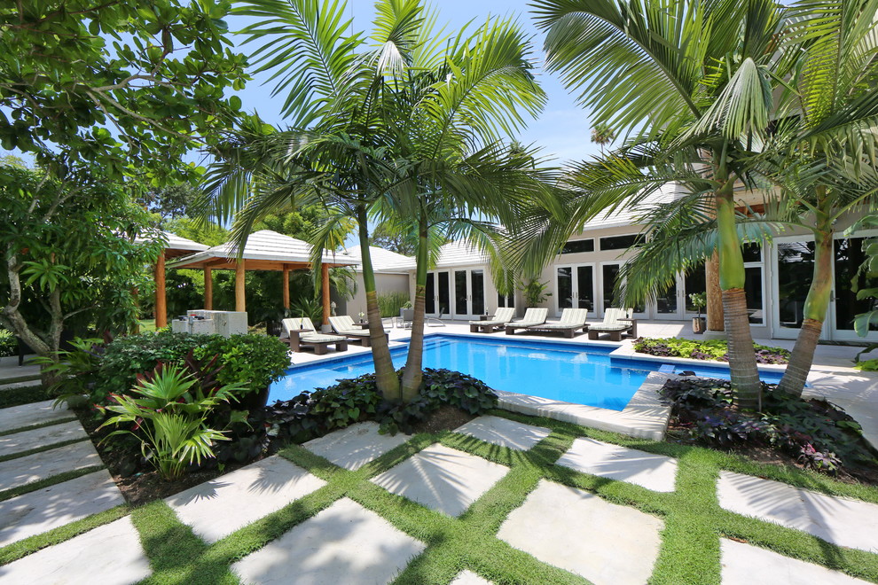 Photo of a tropical custom-shaped pool in Tampa.