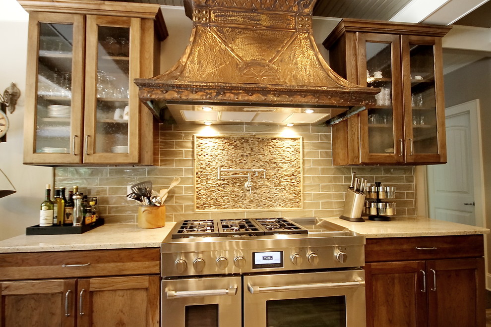 Transitional medium tone wood floor open concept kitchen photo with an undermount sink, flat-panel cabinets, light wood cabinets, granite countertops, beige backsplash, ceramic backsplash, stainless steel appliances and two islands