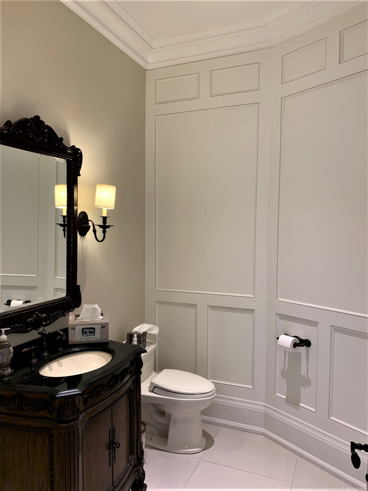 Design ideas for a large contemporary powder room in Toronto with furniture-like cabinets, dark wood cabinets, a two-piece toilet, white walls, porcelain floors, an undermount sink, granite benchtops, brown floor and black benchtops.