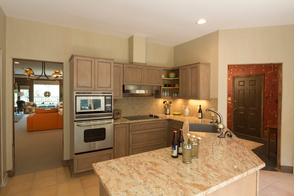 Eat-in kitchen - mid-sized rustic l-shaped ceramic tile and beige floor eat-in kitchen idea with an undermount sink, beaded inset cabinets, distressed cabinets, quartzite countertops, beige backsplash, ceramic backsplash, stainless steel appliances and a peninsula