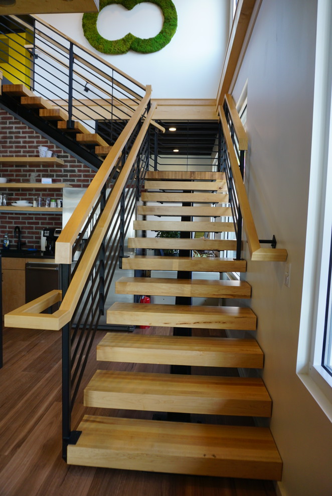 Mid-sized industrial metal l-shaped staircase in Columbus with wood risers and metal railing.