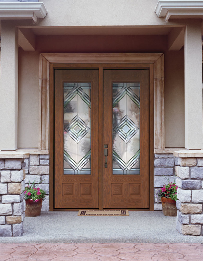 Example of a large front door design with a glass front door
