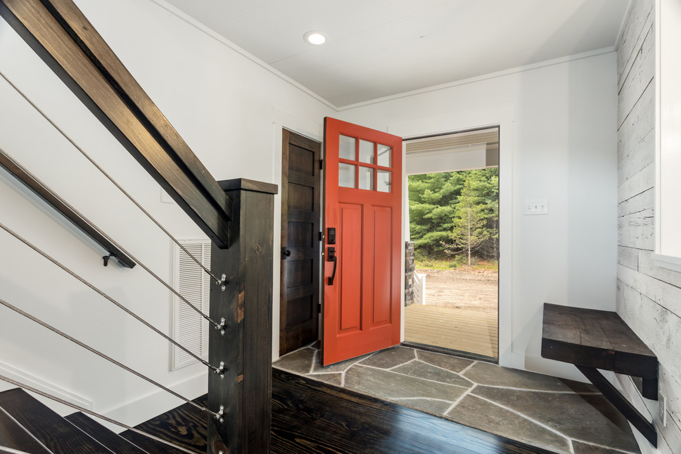 Mid-sized country foyer in New York with white walls, a single front door, a red front door and grey floor.