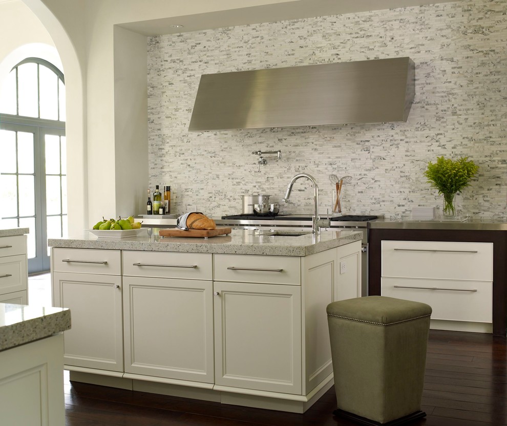 Photo of a transitional kitchen in Houston with recessed-panel cabinets, white cabinets, white splashback, stone tile splashback, dark hardwood floors and with island.