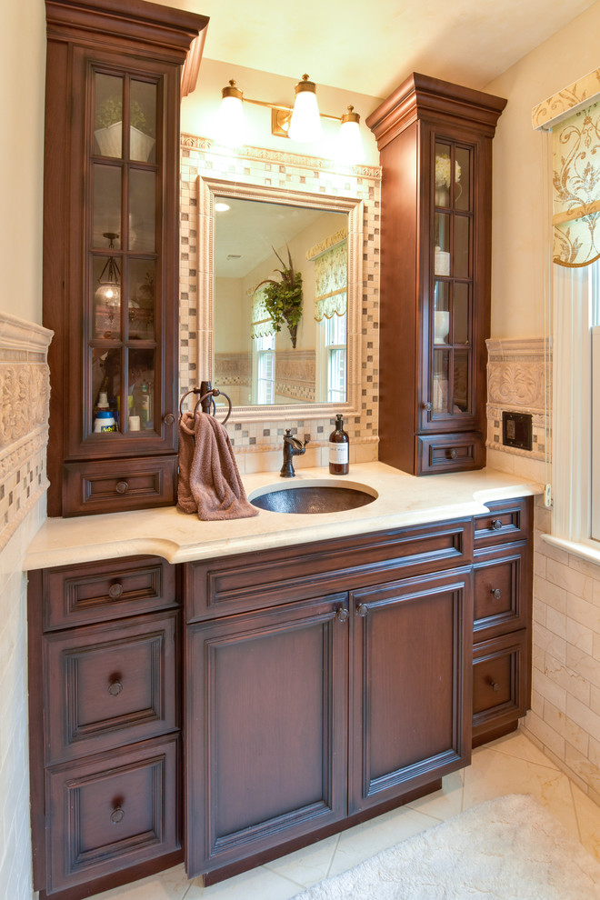 Large traditional master bathroom in DC Metro with beaded inset cabinets, dark wood cabinets, a freestanding tub, an alcove shower, beige tile, limestone, beige walls, limestone floors, an undermount sink, engineered quartz benchtops, beige floor and a hinged shower door.