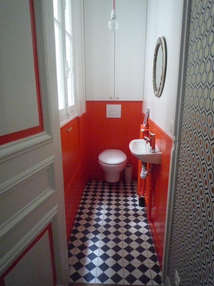 Small transitional powder room in Seville with a wall-mount toilet, white walls, ceramic floors and a wall-mount sink.