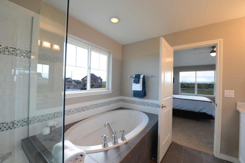 Large arts and crafts master bathroom in Denver with an undermount sink, recessed-panel cabinets, white cabinets, marble benchtops, an undermount tub, a corner shower, a two-piece toilet, gray tile, ceramic tile, beige walls and porcelain floors.