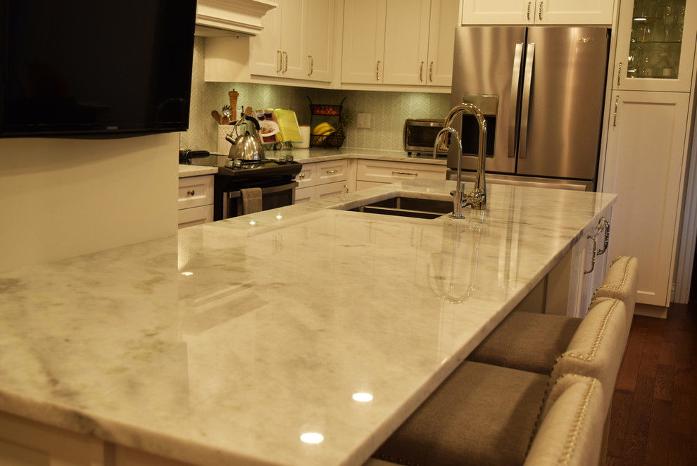 Inspiration for a transitional kitchen remodel with an undermount sink, stainless steel appliances, an island and white countertops