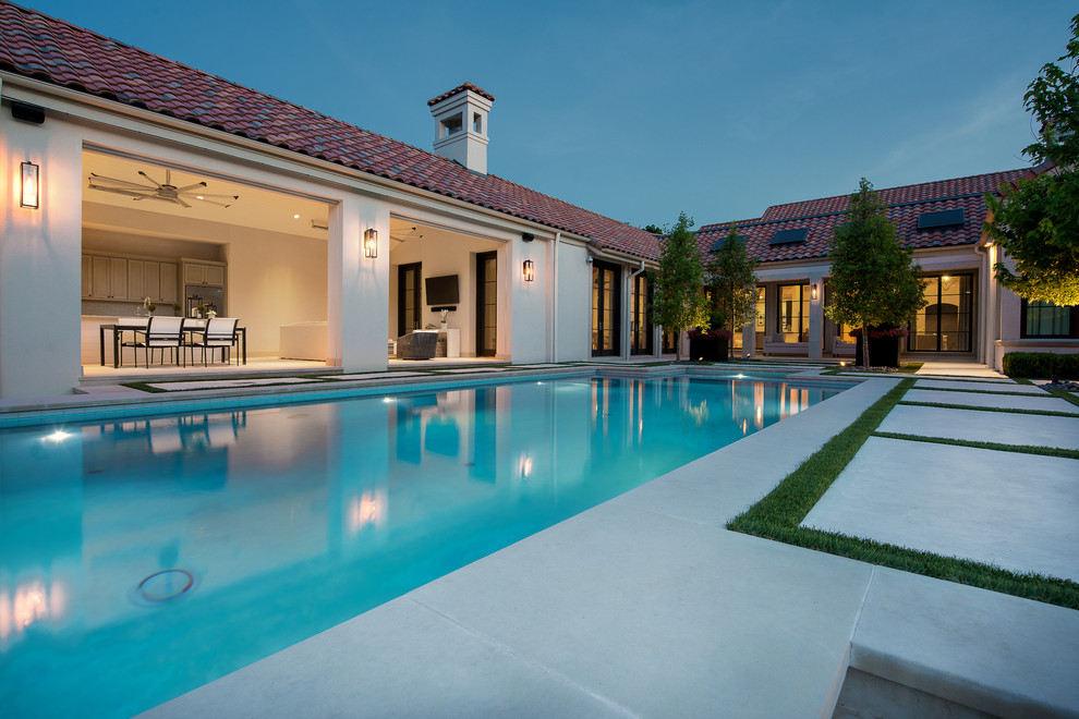 Inspiration for an expansive modern backyard rectangular lap pool in Dallas with a pool house.