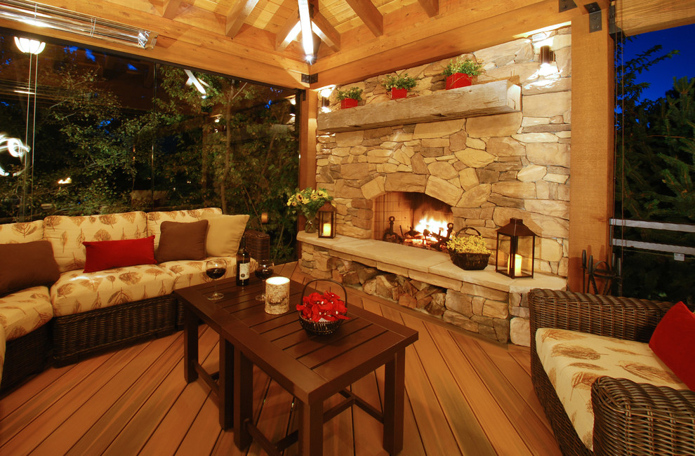 Large country backyard deck in Denver with a pergola and a fire feature.