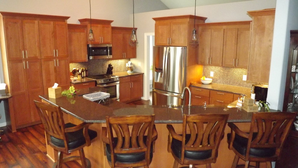 Transitional u-shaped medium tone wood floor open concept kitchen photo with an undermount sink, flat-panel cabinets, medium tone wood cabinets, granite countertops, black backsplash, glass tile backsplash, stainless steel appliances and a peninsula