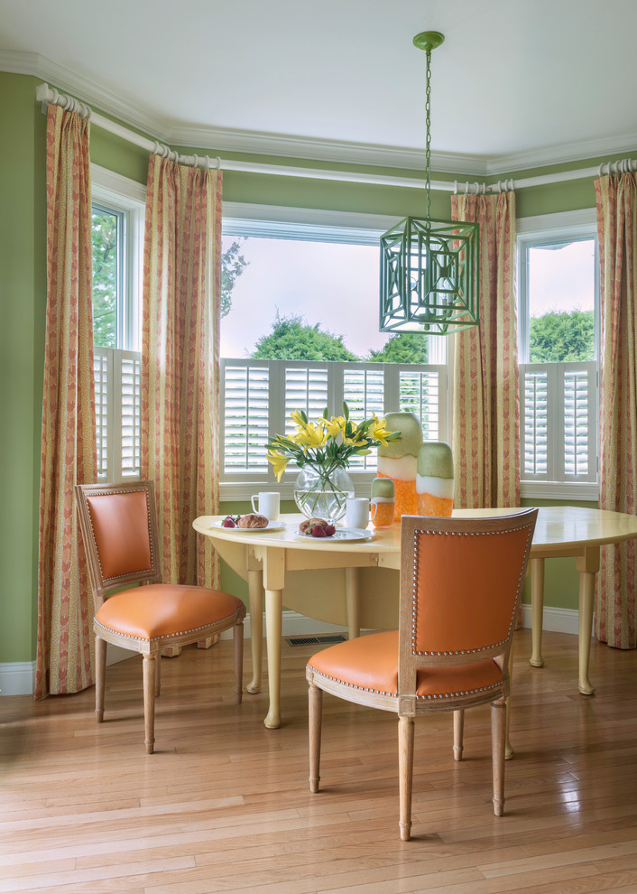 This is an example of a transitional dining room in Providence with grey walls and light hardwood floors.