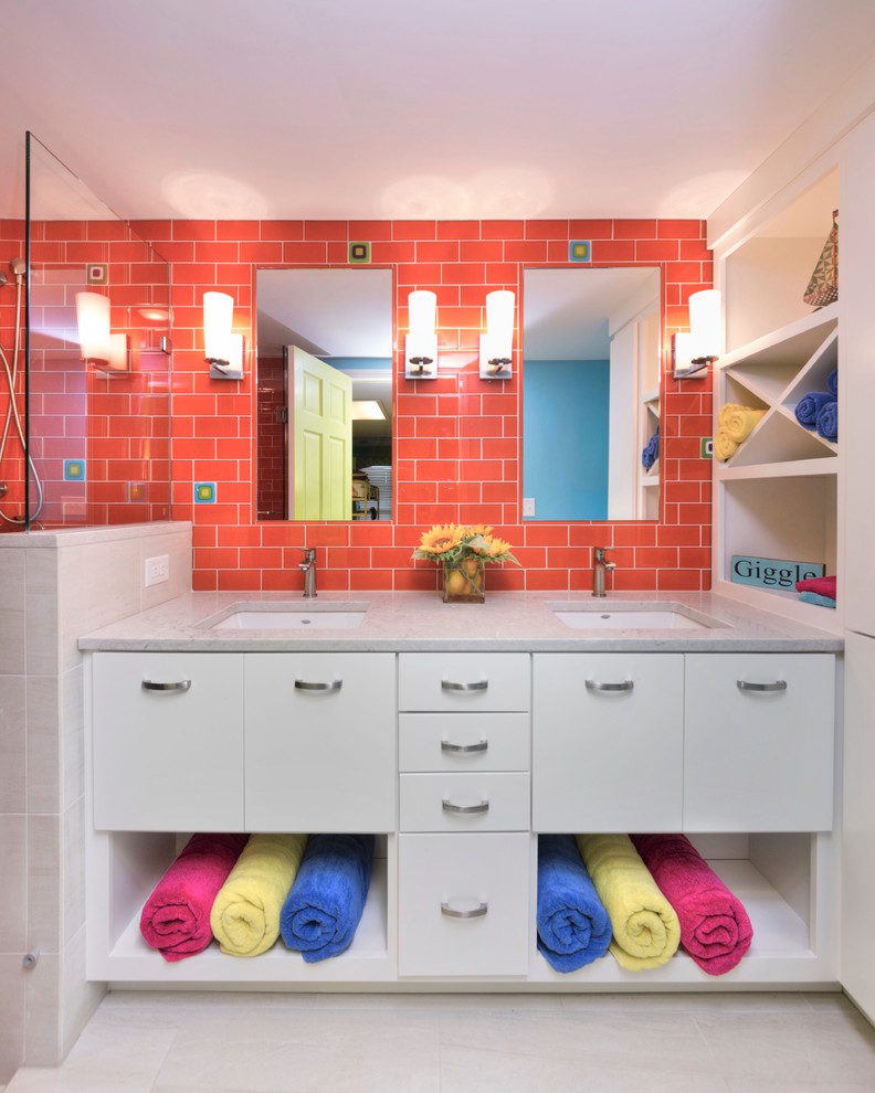 Mid-sized transitional kids bathroom in Other with flat-panel cabinets, white cabinets, an alcove shower, a two-piece toilet, orange tile, glass tile, blue walls, porcelain floors, an undermount sink, engineered quartz benchtops, beige floor and a hinged shower door.