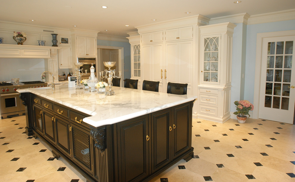 This is an example of a traditional kitchen in New York with glass-front cabinets and stainless steel appliances.