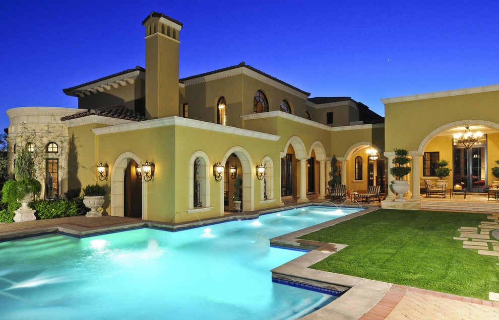 This is an example of a large traditional backyard custom-shaped aboveground pool in Phoenix with a water feature and tile.