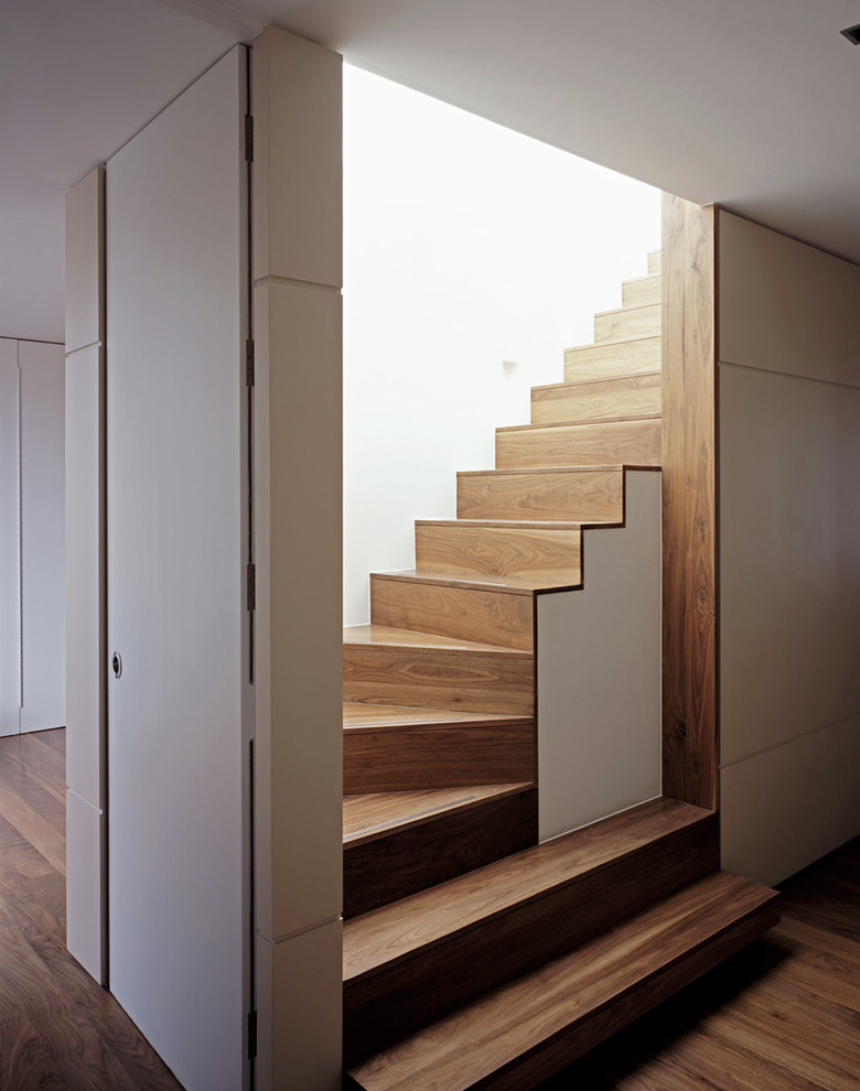 This is an example of a contemporary wood curved staircase in London.