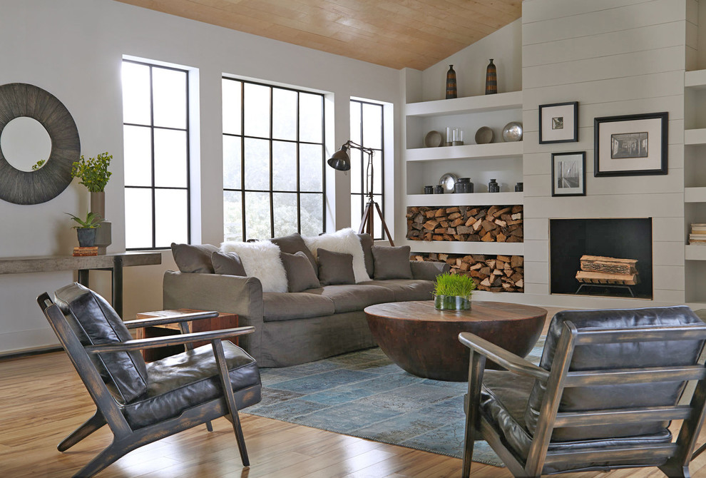 Photo of a transitional living room in New York with white walls and medium hardwood floors.