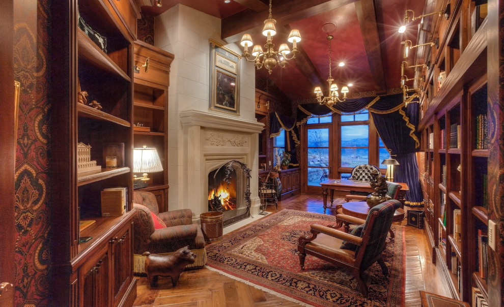 Photo of an expansive traditional study room in Salt Lake City with medium hardwood floors, a standard fireplace, a plaster fireplace surround and a freestanding desk.