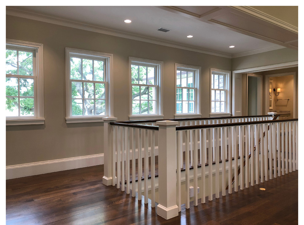 Photo of a mid-sized transitional wood straight staircase in Houston with painted wood risers and wood railing.