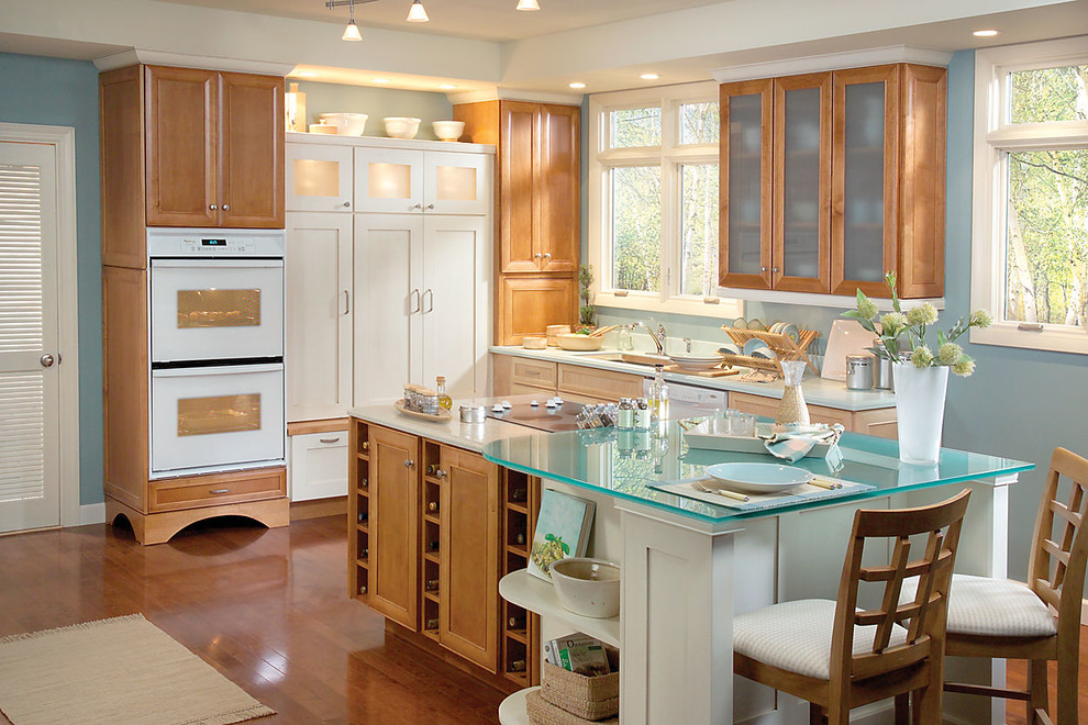 Example of a large transitional l-shaped medium tone wood floor kitchen design in Denver with an undermount sink, recessed-panel cabinets, medium tone wood cabinets, quartz countertops, blue backsplash, white appliances, blue walls and an island