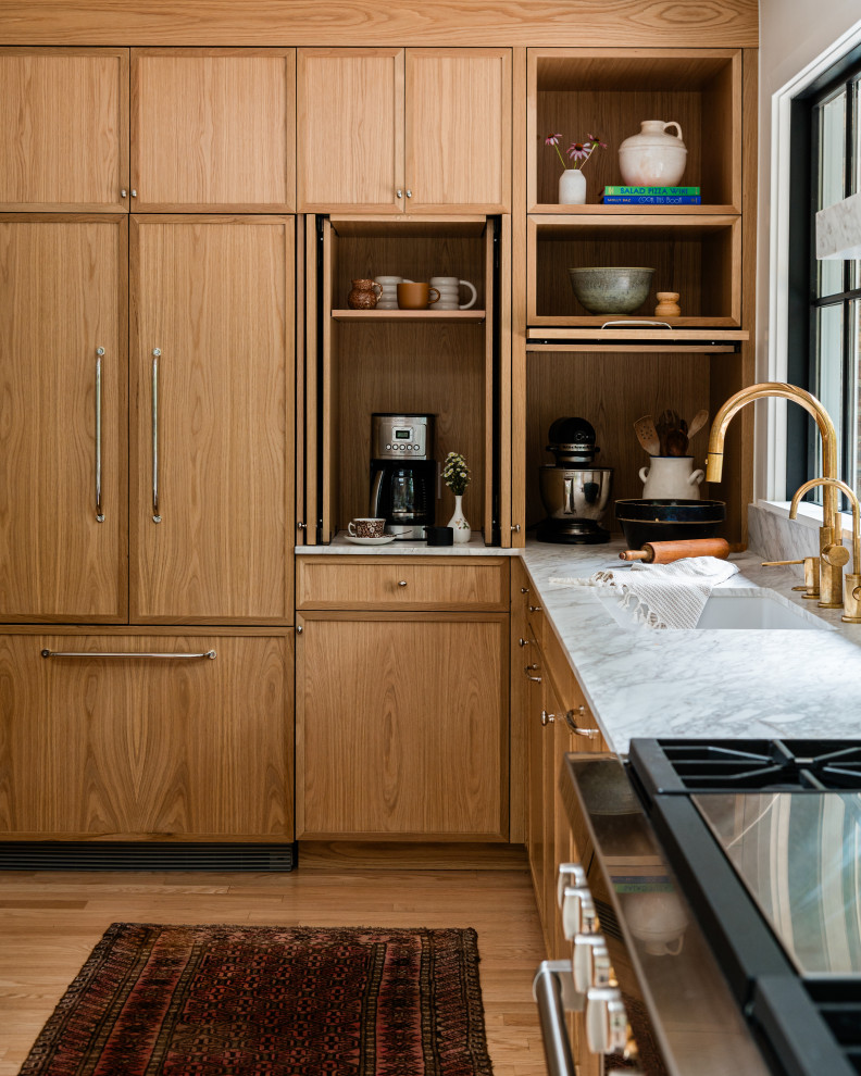 Inspiration for a mid-sized transitional l-shaped light wood floor eat-in kitchen remodel in Chicago with an undermount sink, shaker cabinets, light wood cabinets, marble countertops, white backsplash, marble backsplash, paneled appliances, an island and white countertops
