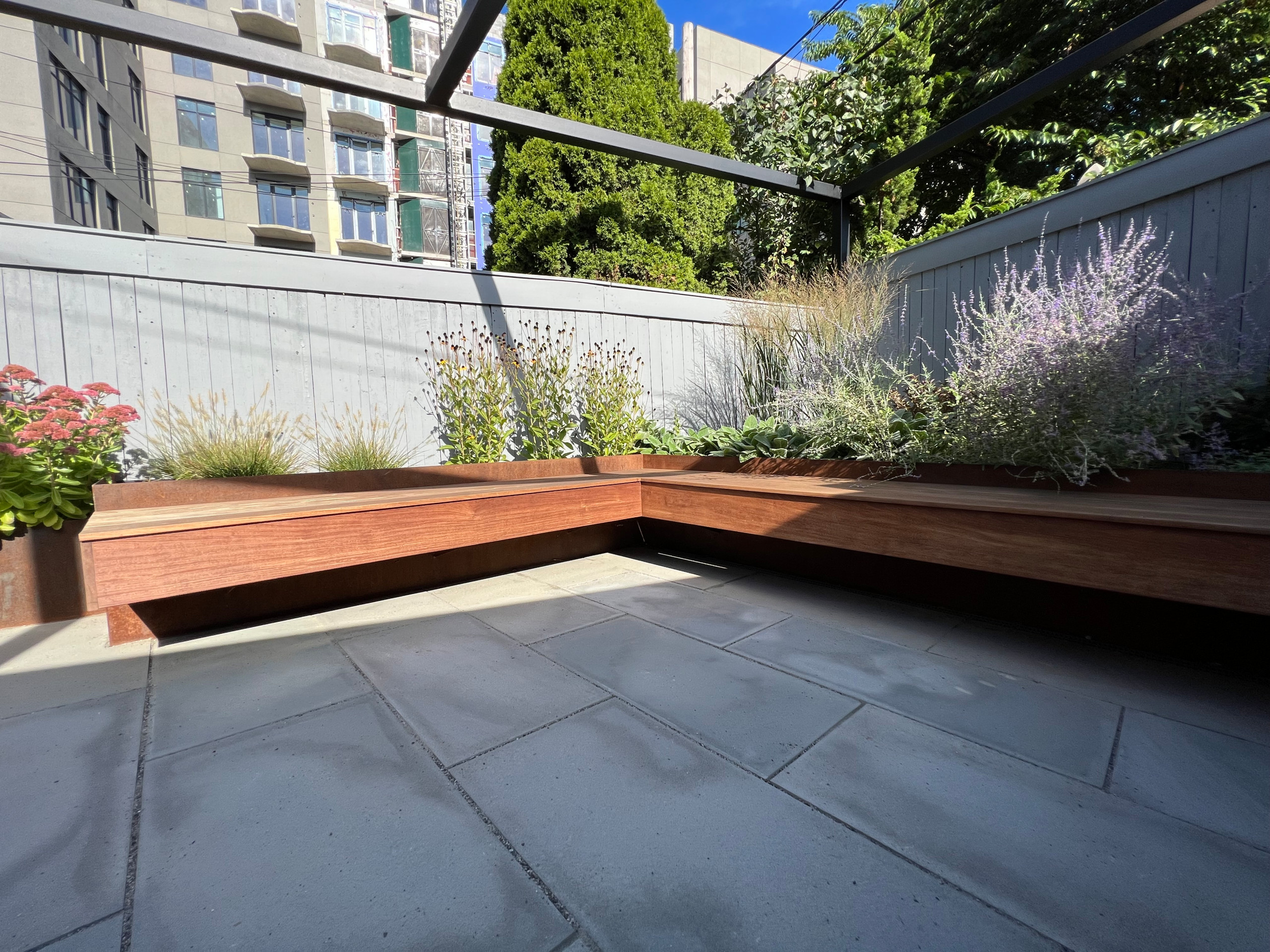 Paved patio with metal grating garden