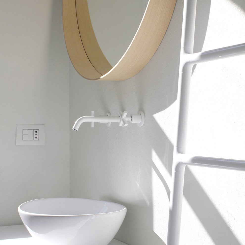 This is an example of a small scandinavian 3/4 bathroom with open cabinets, white cabinets, a corner shower, white tile, subway tile, white walls, light hardwood floors, a vessel sink, white floor, a hinged shower door, white benchtops, a wall-mount toilet, wood benchtops, a single vanity and a floating vanity.