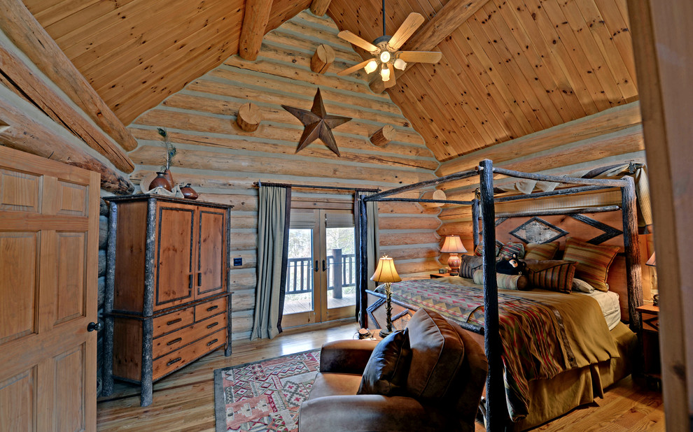 Photo of a traditional bedroom in Atlanta with beige walls and medium hardwood floors.