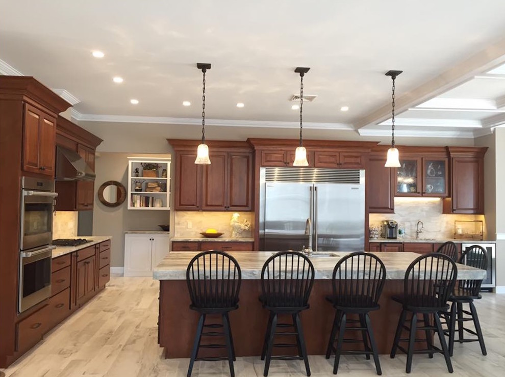 Design ideas for a country eat-in kitchen in Portland Maine with an undermount sink, raised-panel cabinets, dark wood cabinets, granite benchtops, grey splashback, ceramic splashback, stainless steel appliances, ceramic floors and with island.