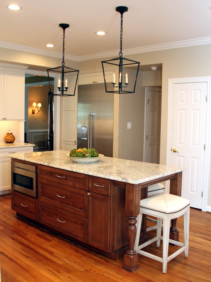 Open concept kitchen - mid-sized transitional u-shaped medium tone wood floor open concept kitchen idea in DC Metro with an undermount sink, recessed-panel cabinets, dark wood cabinets, quartz countertops, white backsplash, glass tile backsplash, stainless steel appliances and an island