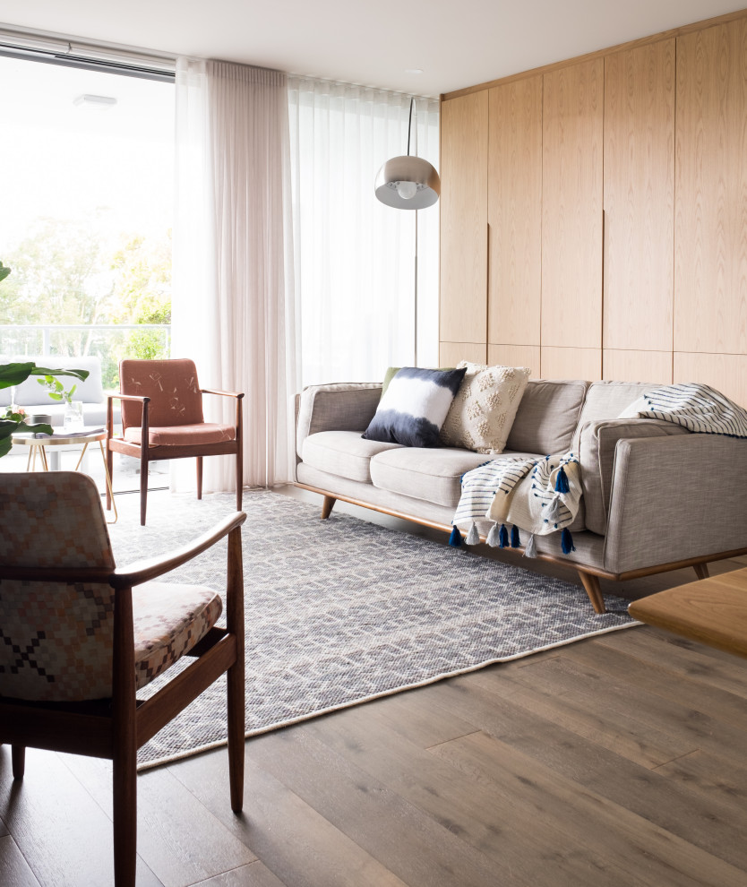 Inspiration for a large contemporary open concept living room in Wollongong with beige walls and brown floor.