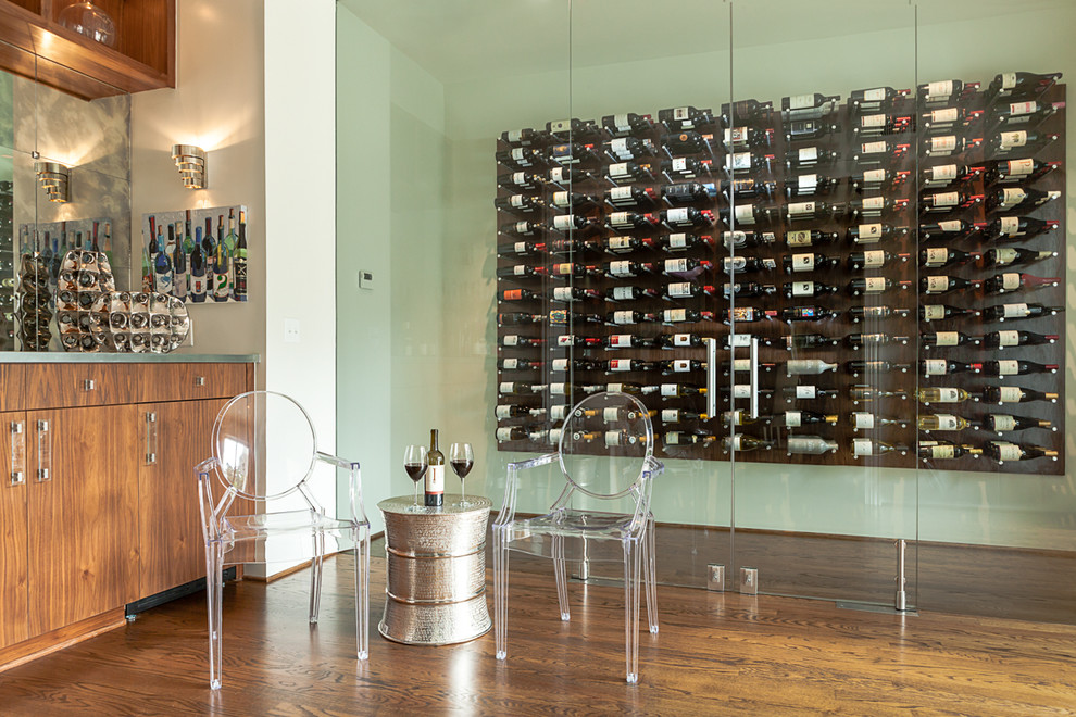 Design ideas for a mid-sized contemporary wine cellar in Raleigh with dark hardwood floors, display racks and brown floor.