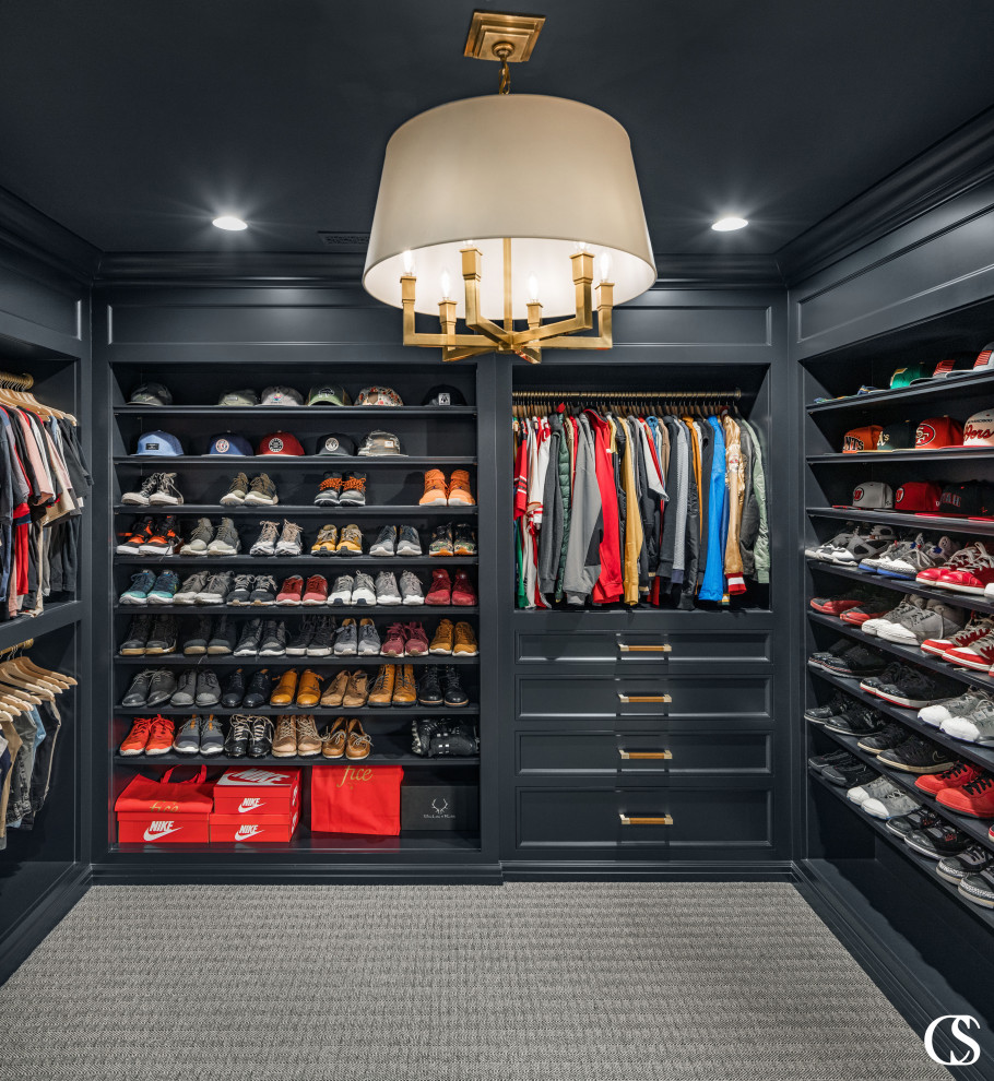 Inspiration for a large traditional men's storage and wardrobe in Salt Lake City with open cabinets, black cabinets, carpet and beige floor.