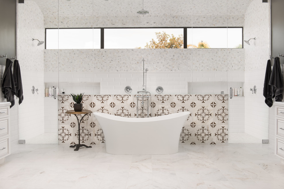 Inspiration for a transitional master bathroom in Phoenix with beaded inset cabinets, white cabinets, a freestanding tub, a double shower, multi-coloured tile, grey walls, white floor and a hinged shower door.