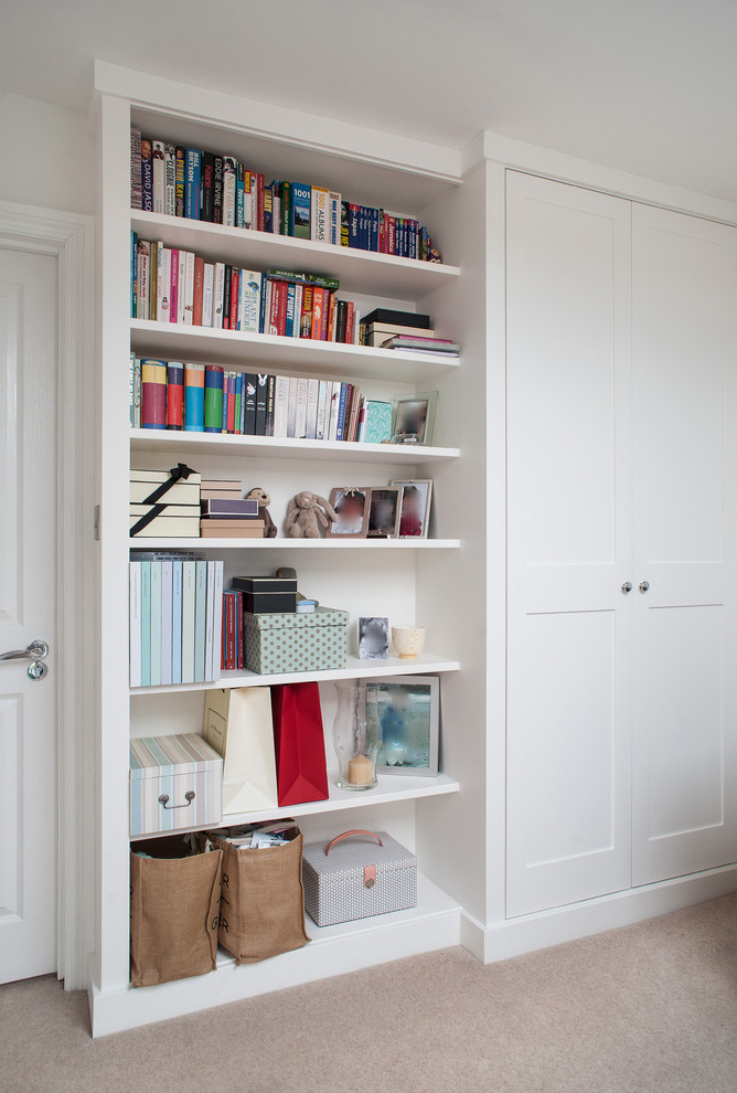 Design ideas for a mid-sized contemporary gender-neutral built-in wardrobe in London with shaker cabinets, white cabinets, carpet and beige floor.