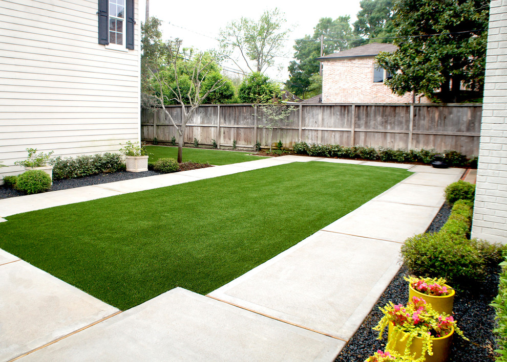 This is an example of a mid-sized contemporary backyard partial sun formal garden in Houston with a garden path and concrete pavers.