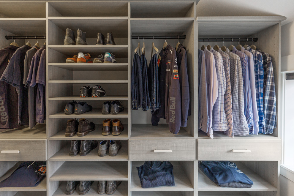 Photo of a large transitional gender-neutral walk-in wardrobe in Seattle with open cabinets, grey cabinets, carpet, white floor and vaulted.